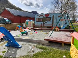 an rv parked in a yard with a playground at Wathne Camping in Bjørheimsbygda