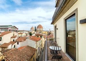a balcony with chairs and a view of the city at Hotel Machiavelli Palace in Florence