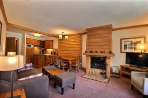 a living room with a table and a fireplace at Auberge jérôme 614 - Arc 1950 - Duplex prestige 4 rooms 3 bedrooms for 6-8 people 5-star residence Auberge Jérôme - village heart in Arc 1950