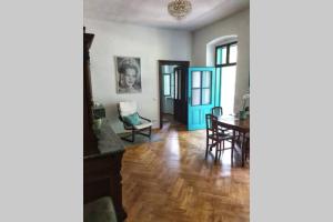 a living room with a table and a blue door at Alte Villa 400m2 Seegrund nur für euch - old villa with 400m2 beach just for you in Maria Wörth