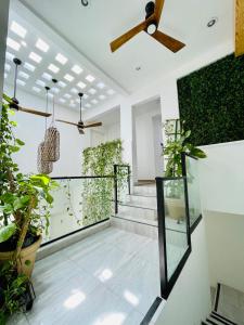 a hallway with plants and stairs in a house at SuitesMB in Playa del Carmen