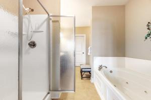 a white bathroom with a shower and a tub at Lake Chatuge Retreat in Hiawassee +30 photos