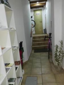 a hallway with stairs and a green door at Apartamentos el Motor Tejeda in Tejeda