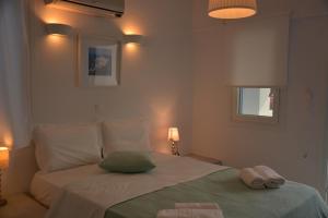 A bed or beds in a room at Drouga's Studios & Suites Astypalaia Greece
