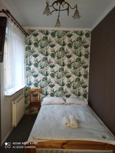 a bedroom with a bed with two towels on it at Hostel Los Amigos in Rzeszów