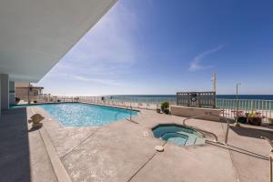 a swimming pool with the ocean in the background at Windemere Beachfront Condo 1503 in Perdido Key