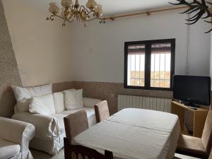 a living room with a couch and a table at Casa Pueblo in Navas de Estena