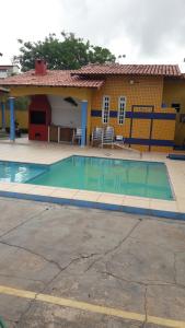 a small swimming pool in front of a house at Chalé Brisa do Mar com Home Office in Salinópolis