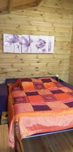 a bedroom with a bed in a wooden wall at gite Labarcarole in Lillers