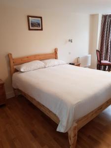 a bedroom with a large bed with white sheets at The Grand Harbour hotel in Ilfracombe