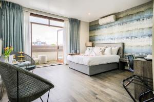 a bedroom with a bed and a large window at Villare Leicester City Centre hotel in Leicester