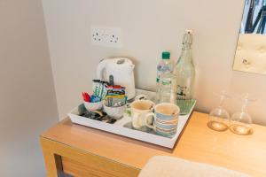 a counter with cups and bottles on a table at Yellowham Farm, Dorchester in Yellowham Wood