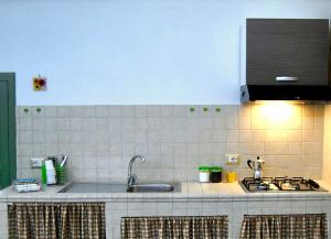 a kitchen counter with a sink and a stove at La Casetta in Oria