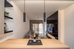 a dining room with a table with wine glasses at Soho City A403 in Bar