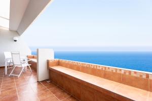 a balcony with a view of the ocean at Listen the ROCKS in Costa Del Silencio