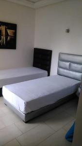 En eller flere senge i et værelse på Ola Blanca Kiki