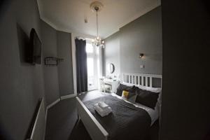 a small bedroom with a bed and a window at The Lansdowne in Hastings