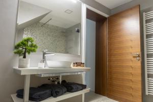 a bathroom with a sink and a mirror at Zabjak5 in Ljubljana +16 photos