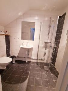 a bathroom with a sink and a shower at Röda Magasinet in Mariefred