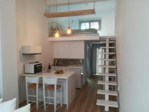 a small kitchen with a counter and a stove top oven at Sixteen All Seasons House in Chania