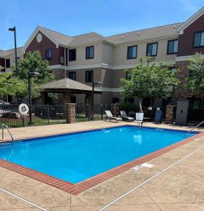 a swimming pool in front of a building at Staybridge Suites Bowling Green, an IHG Hotel in Bowling Green
