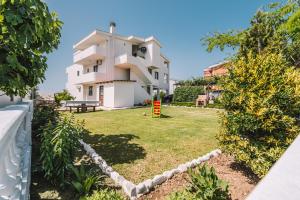a view of a house with a yard at Apartments Radosevic in Ulcinj