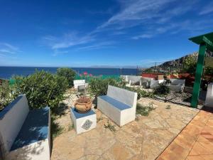 a patio with a view of the ocean at Villa Venere al Sauce - esclusiva villa sul mare in San Vito lo Capo