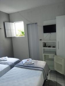 Pousada Atlantico Centro - Fortaleza tesisinde bir odada yatak veya yataklar