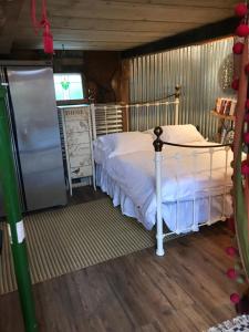 a bedroom with a bed and a tv in a room at The Wackery! in Chiddingfold
