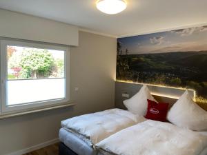 a bedroom with a bed with a large window at Paganetti´s Chalet in Breitscheid