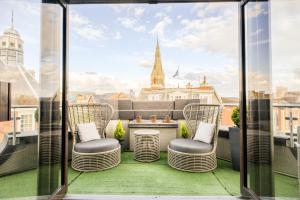 a balcony with chairs and a view of the city at Villare Leicester City Centre hotel in Leicester