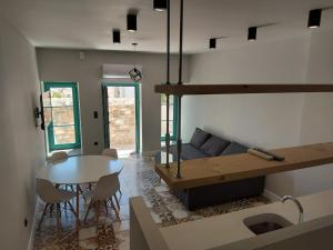 a living room with a couch and a table at Ermoupolis hidden gems in Ermoupoli