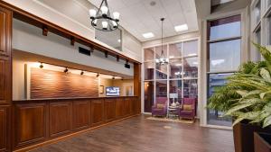 a lobby with wood paneling and purple chairs at Best Western Plaza Inn in Pigeon Forge +28 photos