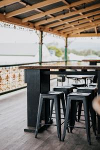 a group of stools sitting in front of a table at Holmesville Hotel in Holmesville +13 photos