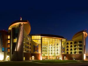 a large building with a lot of windows at night at Sky Ute Casino Resort in Ignacio
