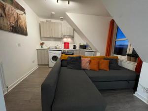 sala de estar con sofá y cocina en Carvetii - Edward House D - 2 Dbl bed 2nd floor flat, en Dunfermline
