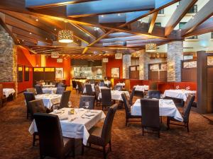 a dining room with white tables and chairs at Sky Ute Casino Resort in Ignacio
