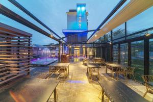 a patio with tables and chairs and a building at Yeon Hwa Moon Hotel in Incheon