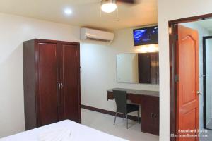 a room with a desk and a sink and a mirror at Lost Horizon Beach Dive Resort in Panglao Island