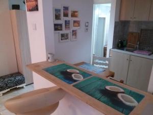 a kitchen with a wooden table with bowls on it at Nice apartments in the center of Athens! in Athens