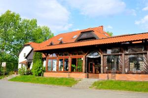 a house with an orange roof at Zajazd Biały Młyn in Sterławki Wielkie