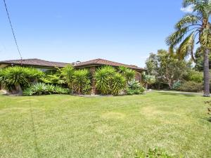 a house with a lawn in front of it at Amersham in Callala Bay