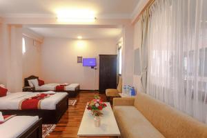 Postel nebo postele na pokoji v ubytování Nepalaya Hotel
