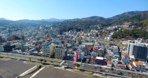 an aerial view of a city with buildings and a highway at Izu no ie MOANA in Ito