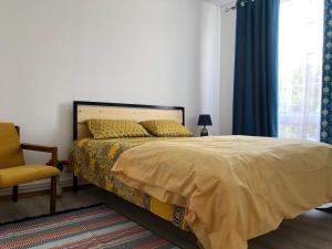 - une chambre avec un lit, une chaise et une fenêtre dans l'établissement Family Guest House, à Cholpon-Ata