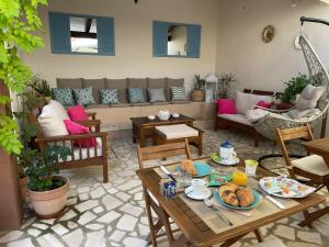 a living room with a couch and a table with food on it at B&b il Patio in Villasimius