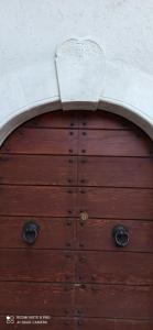 a wooden door leading to a large room at B&B Il Cardinale in Rocca di Mezzo