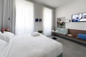 Voodi või voodid majutusasutuse Grand Hotel San Gemini I UNA Esperienze toas