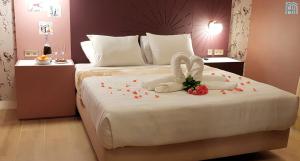 a bedroom with a bed with a swan decoration on it at Happy House Comfort Plus in Faro