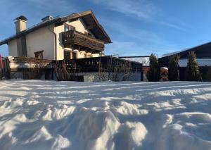 a house with a pile of snow in front of it at Haus Anemone in Seefeld in Tirol